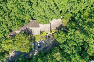 This home sits nestled in a wooded setting and water vista view on Inverness Country Club in Alabama - for sale on GolfHomes.com, golf home, golf lot