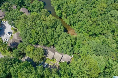This home sits nestled in a wooded setting and water vista view on Inverness Country Club in Alabama - for sale on GolfHomes.com, golf home, golf lot