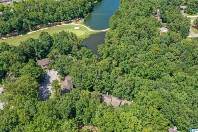 This home sits nestled in a wooded setting and water vista view on Inverness Country Club in Alabama - for sale on GolfHomes.com, golf home, golf lot