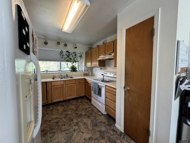 This thoughtfully designed home boasts three generously sized on Riverton Country Club in Wyoming - for sale on GolfHomes.com, golf home, golf lot