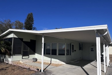 This 940 sq ft home offers an open floor plan and a bright on Lake Henry Golf Club in Florida - for sale on GolfHomes.com, golf home, golf lot
