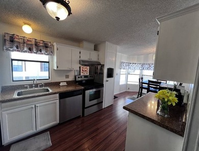 This 940 sq ft home offers an open floor plan and a bright on Lake Henry Golf Club in Florida - for sale on GolfHomes.com, golf home, golf lot