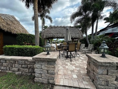 This stunning property is a masterpiece of elegance and on St. Lucie Trail Golf Club in Florida - for sale on GolfHomes.com, golf home, golf lot
