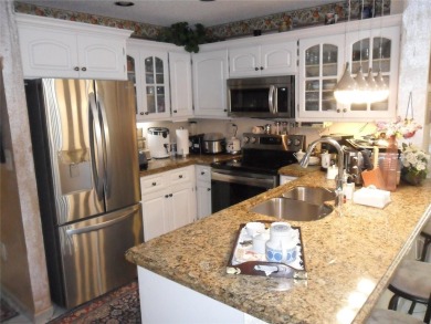 Single-family home in DORAL PARK on a premium lot overlooking on Jim McLean Signature Course in Florida - for sale on GolfHomes.com, golf home, golf lot
