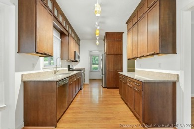A beautifully updated brick home nestled on a peaceful corner on Kings Grant Golf and Country Club in North Carolina - for sale on GolfHomes.com, golf home, golf lot