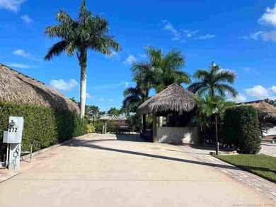 Peaceful Waterfront Lot with Tropical Views and Cozy Tiki on St. Lucie Trail Golf Club in Florida - for sale on GolfHomes.com, golf home, golf lot