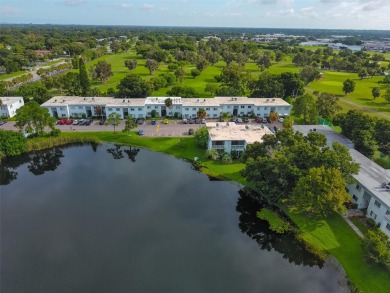 Discover serene and low-maintenance lakeside living in the heart on Clearwater Executive Golf Course in Florida - for sale on GolfHomes.com, golf home, golf lot