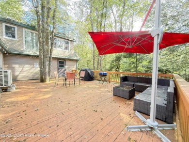 Nestled on a wooded lot backing up to the golf course, this on Pocono Farms Country Club in Pennsylvania - for sale on GolfHomes.com, golf home, golf lot