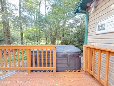 Nestled on a wooded lot backing up to the golf course, this on Pocono Farms Country Club in Pennsylvania - for sale on GolfHomes.com, golf home, golf lot