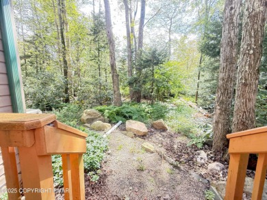 Nestled on a wooded lot backing up to the golf course, this on Pocono Farms Country Club in Pennsylvania - for sale on GolfHomes.com, golf home, golf lot