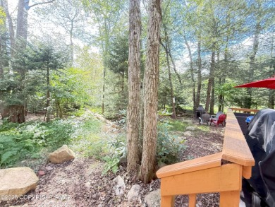 Nestled on a wooded lot backing up to the golf course, this on Pocono Farms Country Club in Pennsylvania - for sale on GolfHomes.com, golf home, golf lot