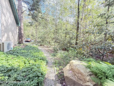 Nestled on a wooded lot backing up to the golf course, this on Pocono Farms Country Club in Pennsylvania - for sale on GolfHomes.com, golf home, golf lot