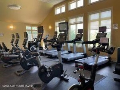 Nestled on a wooded lot backing up to the golf course, this on Pocono Farms Country Club in Pennsylvania - for sale on GolfHomes.com, golf home, golf lot