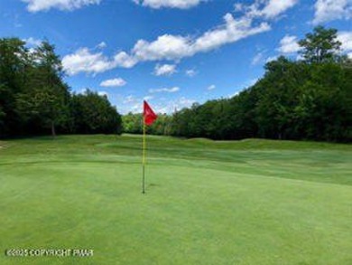 Nestled on a wooded lot backing up to the golf course, this on Pocono Farms Country Club in Pennsylvania - for sale on GolfHomes.com, golf home, golf lot