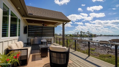 Experience waterfront living in Bay Point with front-row seats on Bay Point Resort Golf Club in Florida - for sale on GolfHomes.com, golf home, golf lot