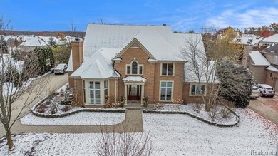 Perched gracefully above the landscape, this Oakhurst residence on Oakhurst Golf and Country Club in Michigan - for sale on GolfHomes.com, golf home, golf lot