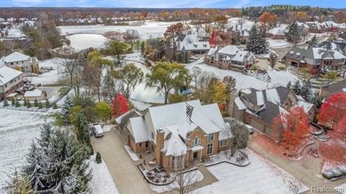 Perched gracefully above the landscape, this Oakhurst residence on Oakhurst Golf and Country Club in Michigan - for sale on GolfHomes.com, golf home, golf lot