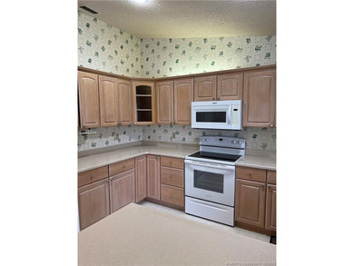 Needs TLC...the future buyer will remodel this home and at this on Martin Downs Country Club in Florida - for sale on GolfHomes.com, golf home, golf lot