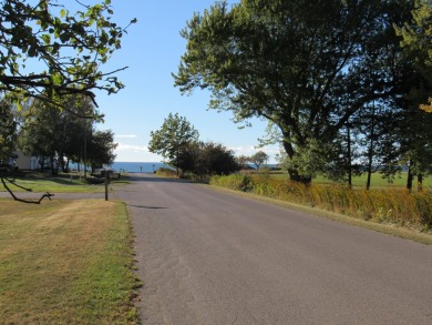 This buildable lot offers incredible views that are sure to on Manistee Golf and Country Club in Michigan - for sale on GolfHomes.com, golf home, golf lot