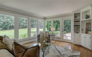 Classic white brick beauty nestled on the 16th fairway of Forest on Forest Oaks Country Club in North Carolina - for sale on GolfHomes.com, golf home, golf lot