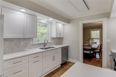 Classic white brick beauty nestled on the 16th fairway of Forest on Forest Oaks Country Club in North Carolina - for sale on GolfHomes.com, golf home, golf lot