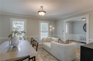 Classic white brick beauty nestled on the 16th fairway of Forest on Forest Oaks Country Club in North Carolina - for sale on GolfHomes.com, golf home, golf lot
