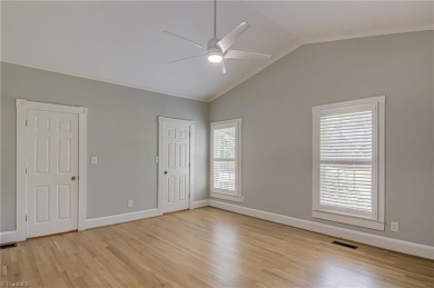 Classic white brick beauty nestled on the 16th fairway of Forest on Forest Oaks Country Club in North Carolina - for sale on GolfHomes.com, golf home, golf lot
