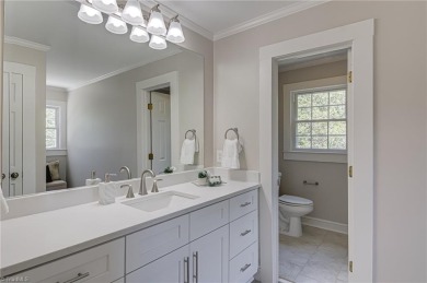 Classic white brick beauty nestled on the 16th fairway of Forest on Forest Oaks Country Club in North Carolina - for sale on GolfHomes.com, golf home, golf lot