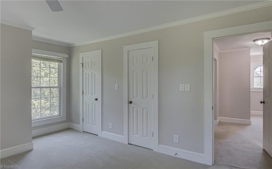 Classic white brick beauty nestled on the 16th fairway of Forest on Forest Oaks Country Club in North Carolina - for sale on GolfHomes.com, golf home, golf lot
