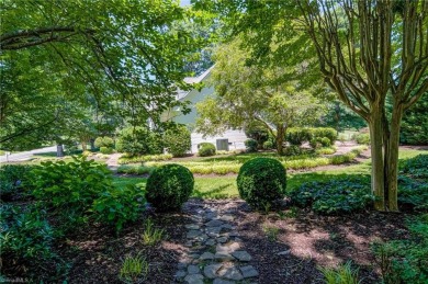 Classic white brick beauty nestled on the 16th fairway of Forest on Forest Oaks Country Club in North Carolina - for sale on GolfHomes.com, golf home, golf lot