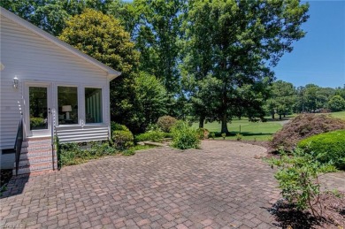 Classic white brick beauty nestled on the 16th fairway of Forest on Forest Oaks Country Club in North Carolina - for sale on GolfHomes.com, golf home, golf lot