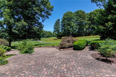 Classic white brick beauty nestled on the 16th fairway of Forest on Forest Oaks Country Club in North Carolina - for sale on GolfHomes.com, golf home, golf lot
