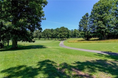 Classic white brick beauty nestled on the 16th fairway of Forest on Forest Oaks Country Club in North Carolina - for sale on GolfHomes.com, golf home, golf lot