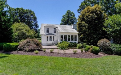 Classic white brick beauty nestled on the 16th fairway of Forest on Forest Oaks Country Club in North Carolina - for sale on GolfHomes.com, golf home, golf lot