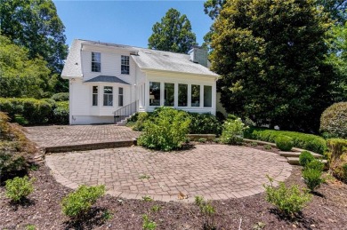 Classic white brick beauty nestled on the 16th fairway of Forest on Forest Oaks Country Club in North Carolina - for sale on GolfHomes.com, golf home, golf lot