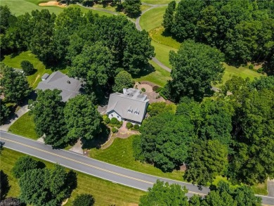 Classic white brick beauty nestled on the 16th fairway of Forest on Forest Oaks Country Club in North Carolina - for sale on GolfHomes.com, golf home, golf lot