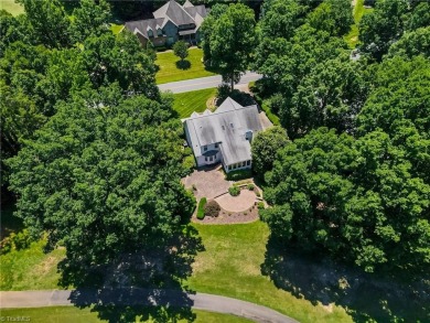 Classic white brick beauty nestled on the 16th fairway of Forest on Forest Oaks Country Club in North Carolina - for sale on GolfHomes.com, golf home, golf lot