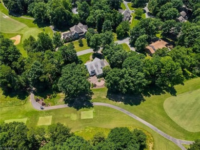 Classic white brick beauty nestled on the 16th fairway of Forest on Forest Oaks Country Club in North Carolina - for sale on GolfHomes.com, golf home, golf lot