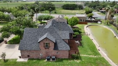 Experience serene pond-side living in this expertly crafted home on Harlingen Country Club in Texas - for sale on GolfHomes.com, golf home, golf lot