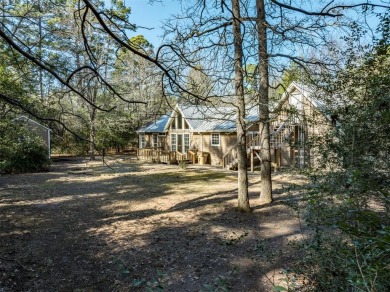 Beautiful home nestled in a private cove with abundance of trees on Holly Lake Ranch Golf Club in Texas - for sale on GolfHomes.com, golf home, golf lot