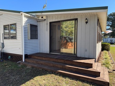 Oversized lot with park trailer, septic, room addition, deck on Captains Cove Golf and Yacht Club in Virginia - for sale on GolfHomes.com, golf home, golf lot