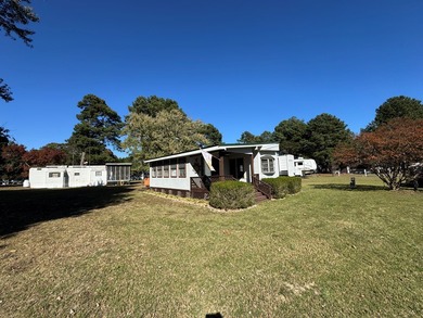 Oversized lot with park trailer, septic, room addition, deck on Captains Cove Golf and Yacht Club in Virginia - for sale on GolfHomes.com, golf home, golf lot