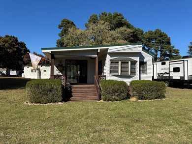 Oversized lot with park trailer, septic, room addition, deck on Captains Cove Golf and Yacht Club in Virginia - for sale on GolfHomes.com, golf home, golf lot