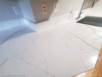 Beautifully updated end-unit brick condo in the highly desirable on Great Oaks Country Club in Michigan - for sale on GolfHomes.com, golf home, golf lot