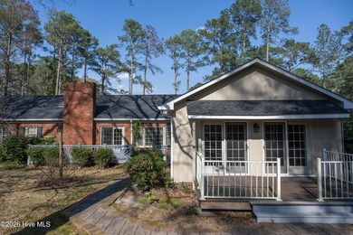 Discover a sanctuary of quiet elegance at 614 Lake Shore Drive on Walnut Creek Country Club in North Carolina - for sale on GolfHomes.com, golf home, golf lot
