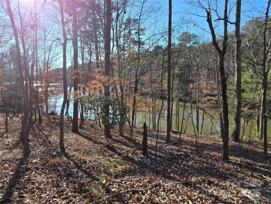 This Badin Lake waterfront lot is located in the prestigious on Old North State Club at Uwharrie Point Golf community in North Carolina - for sale on GolfHomes.com, golf home, golf lot