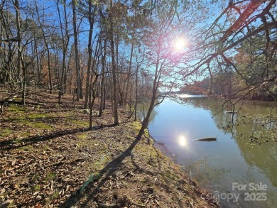 This Badin Lake waterfront lot is located in the prestigious on Old North State Club at Uwharrie Point Golf community in North Carolina - for sale on GolfHomes.com, golf home, golf lot