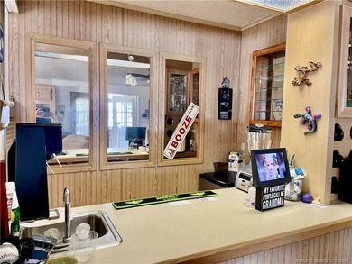 Lovely 2-bedroom, 2 bath home with 2 outdoor living spaces on Indianwood Golf and Country Club in Florida - for sale on GolfHomes.com, golf home, golf lot