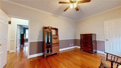 Imagine mornings on your spacious covered front porch or on Okefenokee Country Club in Georgia - for sale on GolfHomes.com, golf home, golf lot