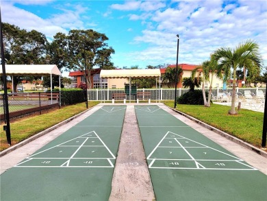 Meticulously maintained end unit with updated kitchen and baths on The American Golf Club in Florida - for sale on GolfHomes.com, golf home, golf lot